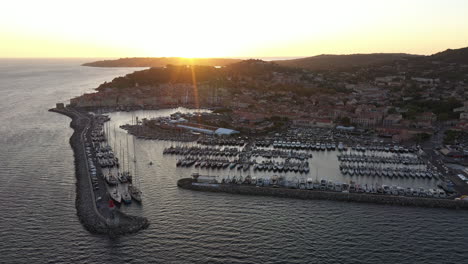 Port-of-Saint-Tropez-full-of-sailing-boats-Voiles-de-Saint-Tropez-sunrise-aerial